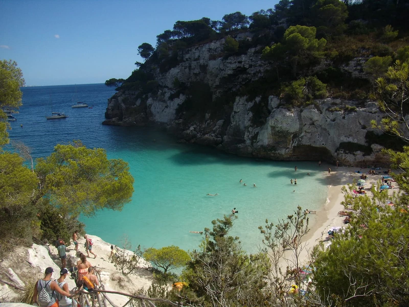 Cala Macarelleta, Menorca, Spain - view from the cliff path over the cove's white sand and clear blue water