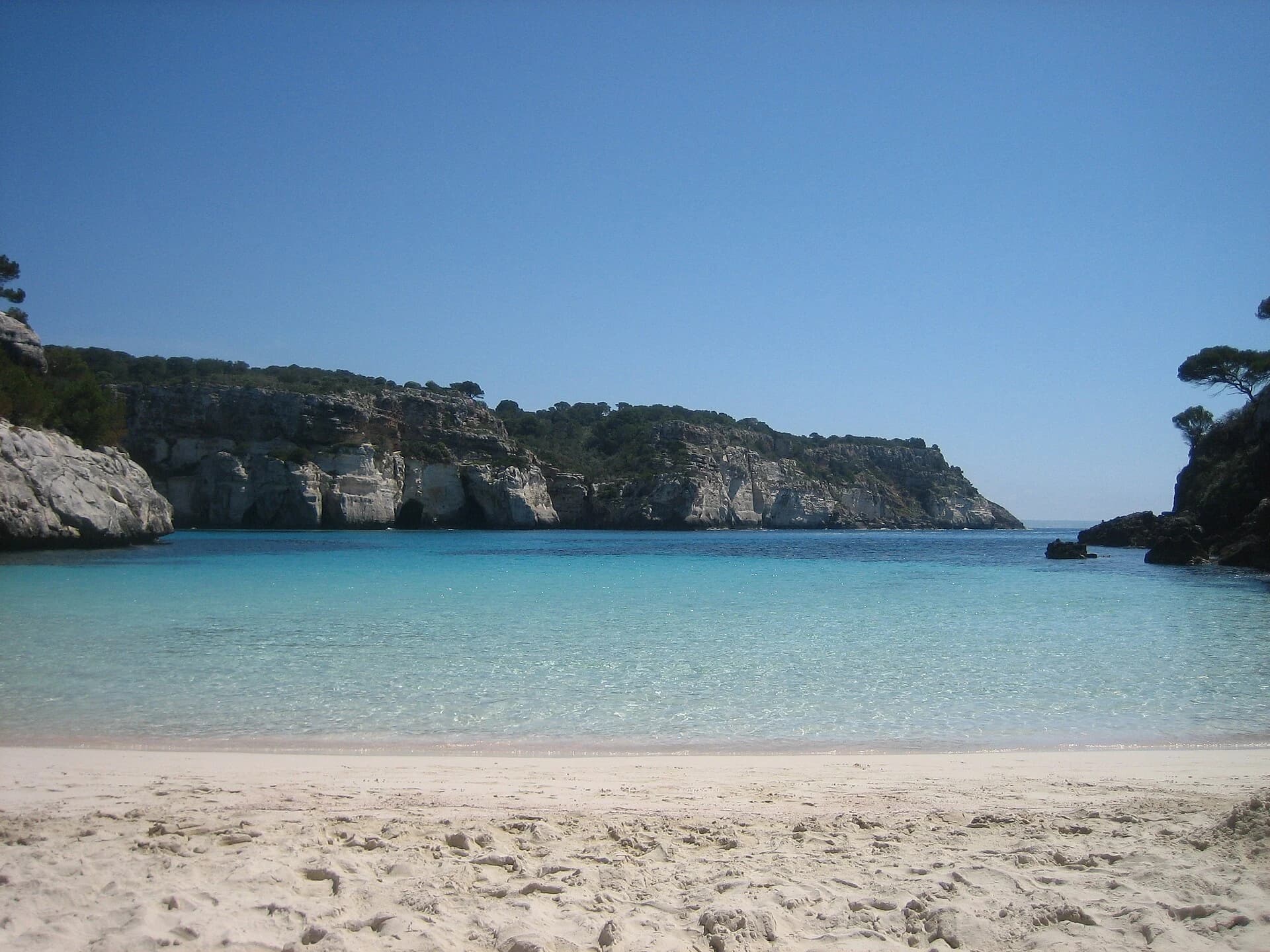 Cala Macarelleta, Menorca, Spain — turquoise shallows and white sand seen from the beach