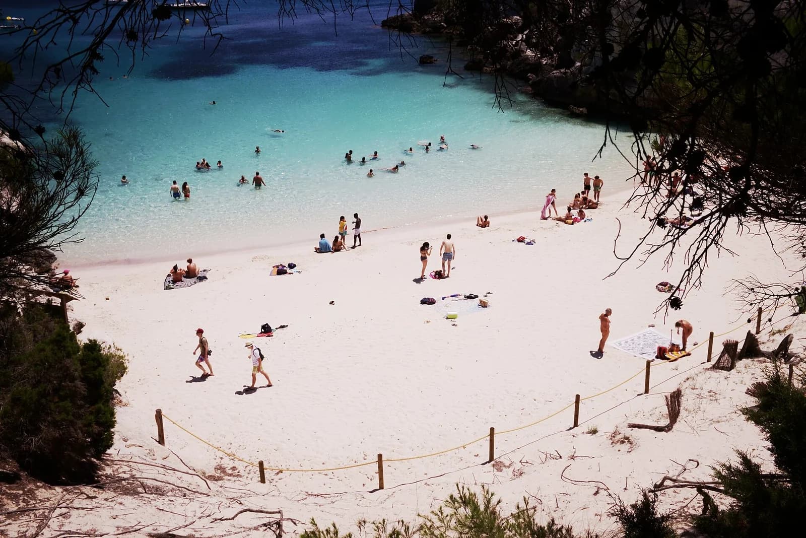 Cala Macarelleta, Menorca, Spain - overhead view of the sandy beach and swimmers in the clear shallows