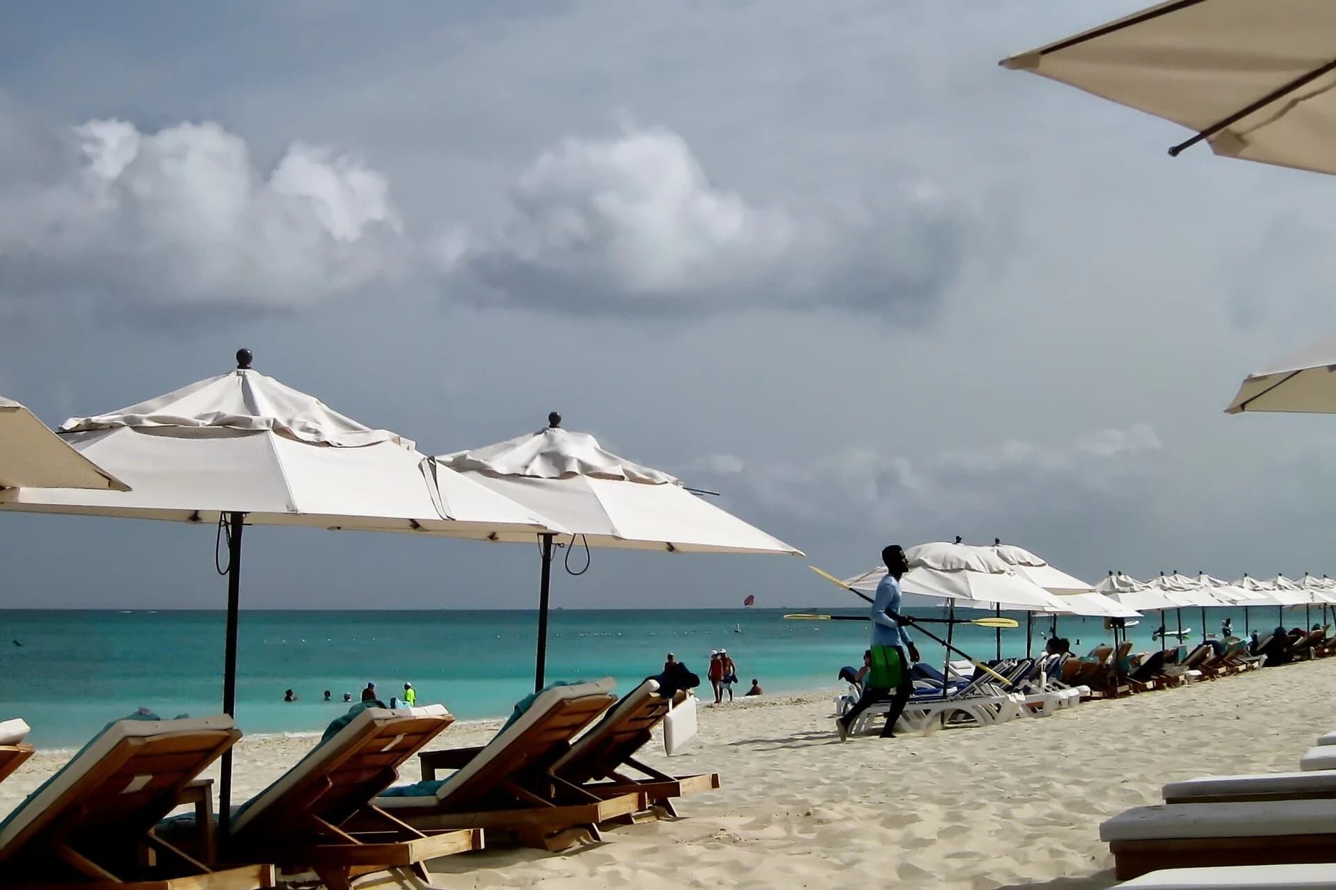 Grace Bay, Providenciales, Turks and Caicos - beachfront umbrellas and loungers under a dramatic sky