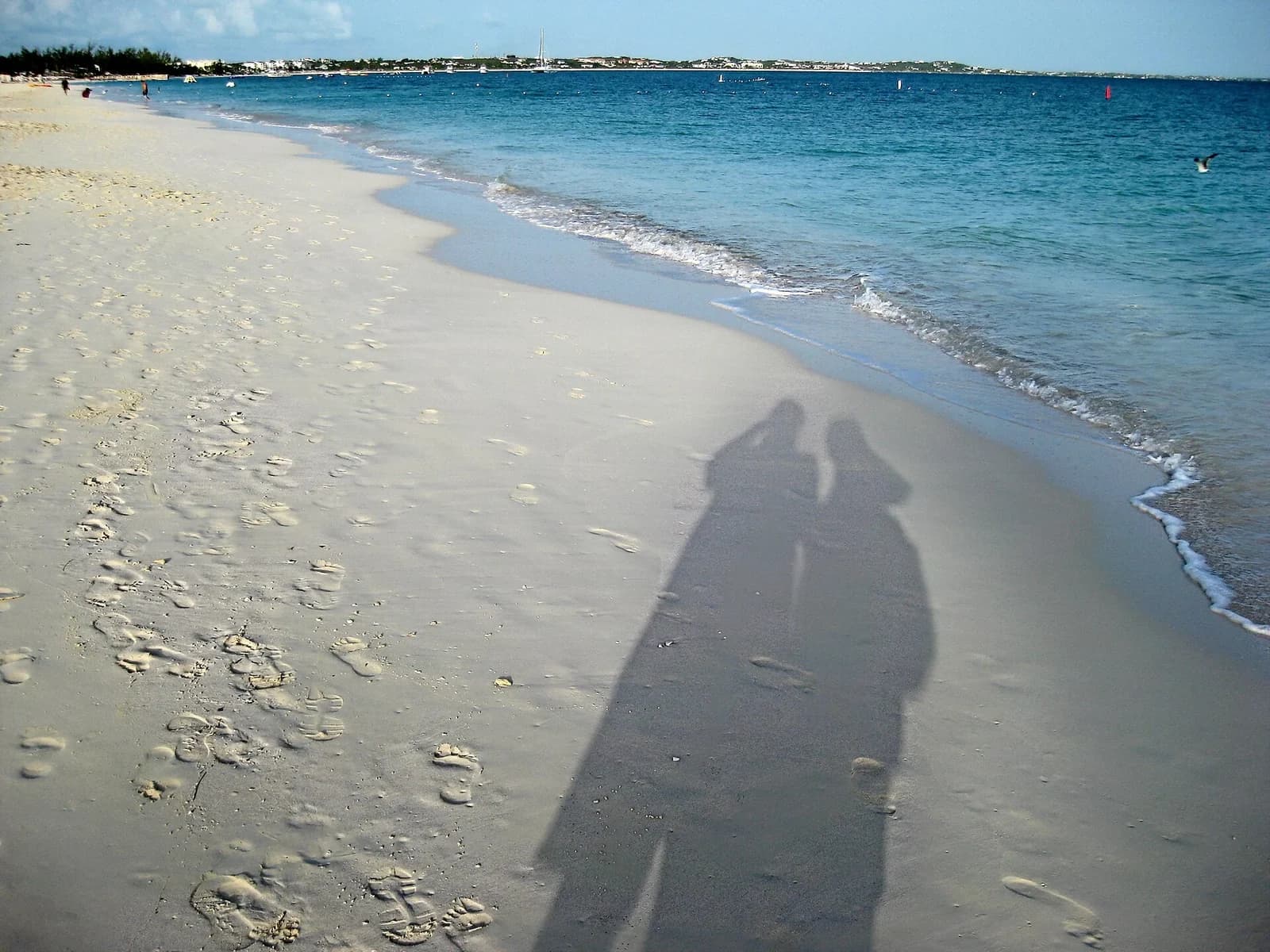 Grace Bay, Providenciales, Turks and Caicos - footprints along the curving shoreline at the water's edge