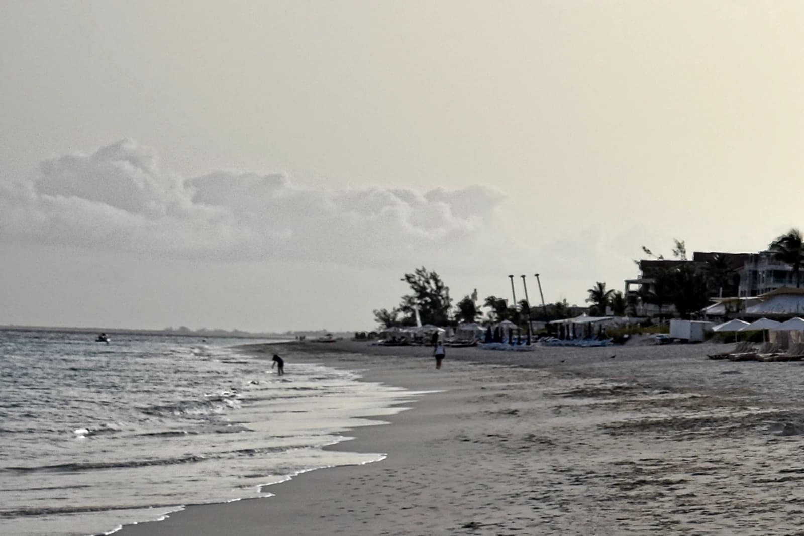 Grace Bay, Providenciales, Turks and Caicos - wide view of the resort-lined shore under a soft sky