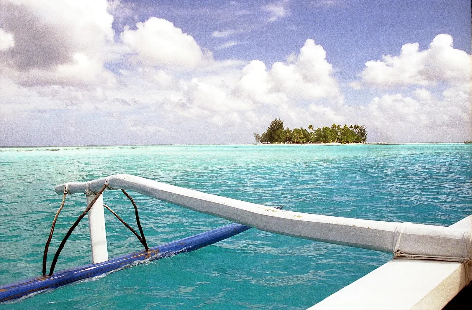 Matira Beach, Bora Bora, French Polynesia - turquoise lagoon shallows and a palm-fringed islet offshore