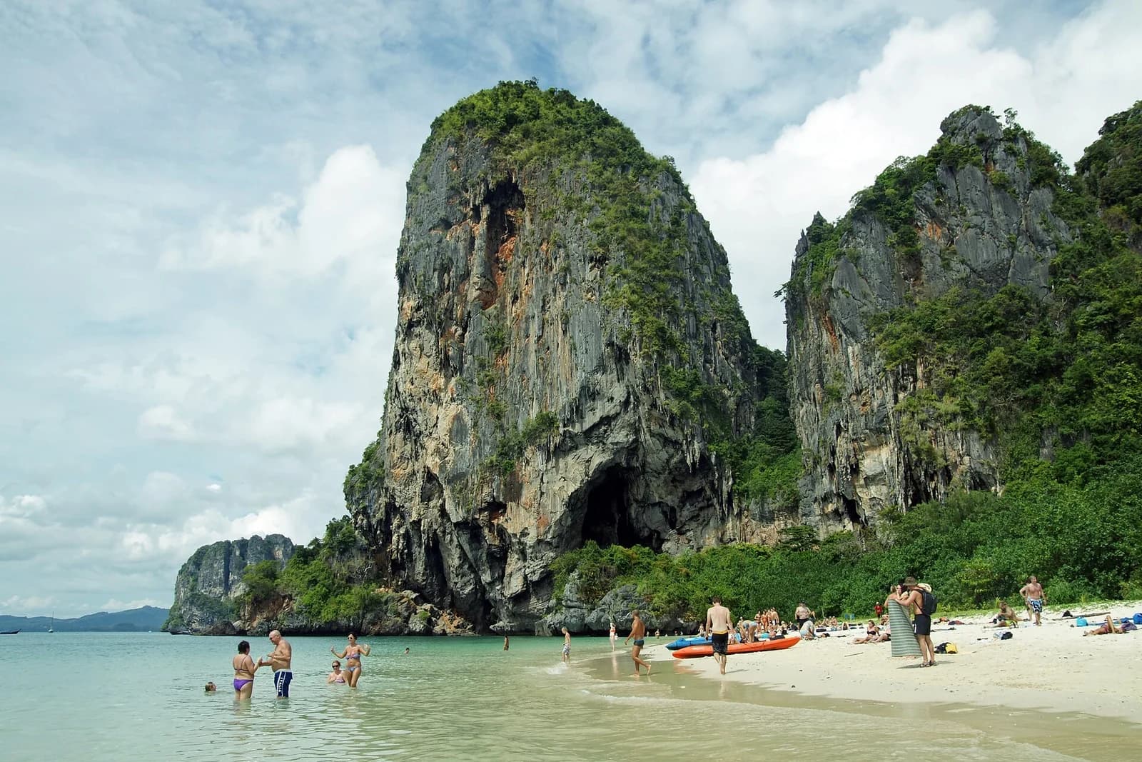 Railay Beach, Krabi, Thailand - towering cave-pocked limestone tower above the white sand of Phra Nang beach
