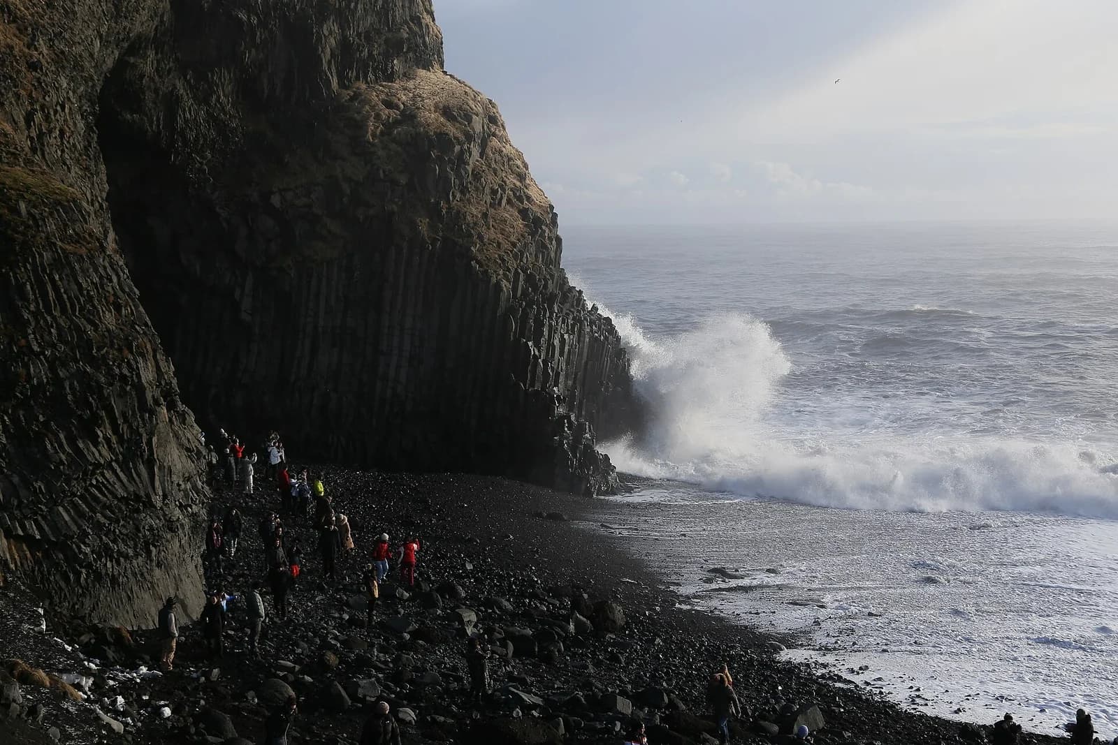 Reynisfjara, South Iceland - waves crashing below the towering basalt cliff on the black sand beach