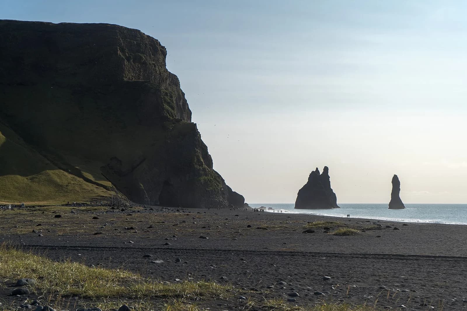 Reynisfjara, South Iceland - black sand beach with the cliff and the Reynisdrangar sea stacks at low light