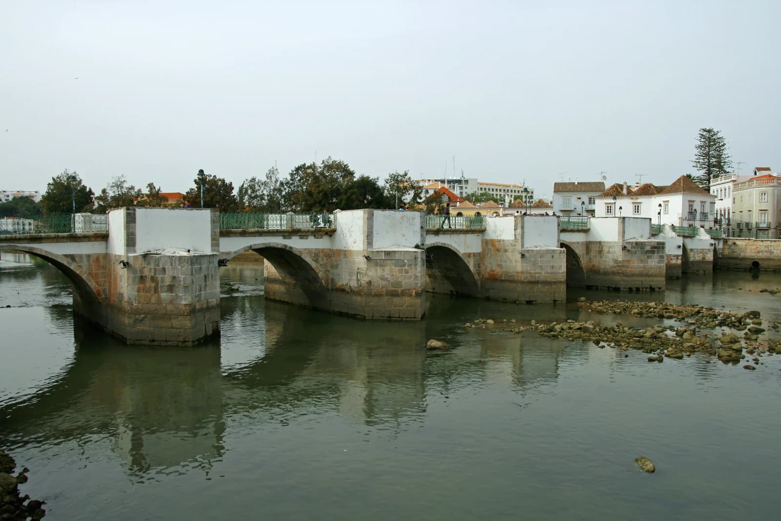 The old arched bridge over the Gilão river in the centre of Tavira