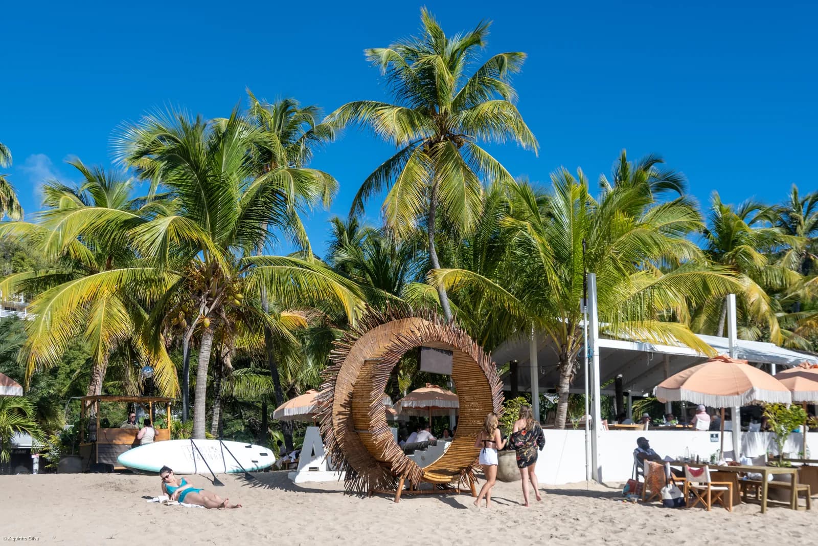 Palm trees and sun loungers on the beach at Freeman's Bay in English Harbour, Antigua