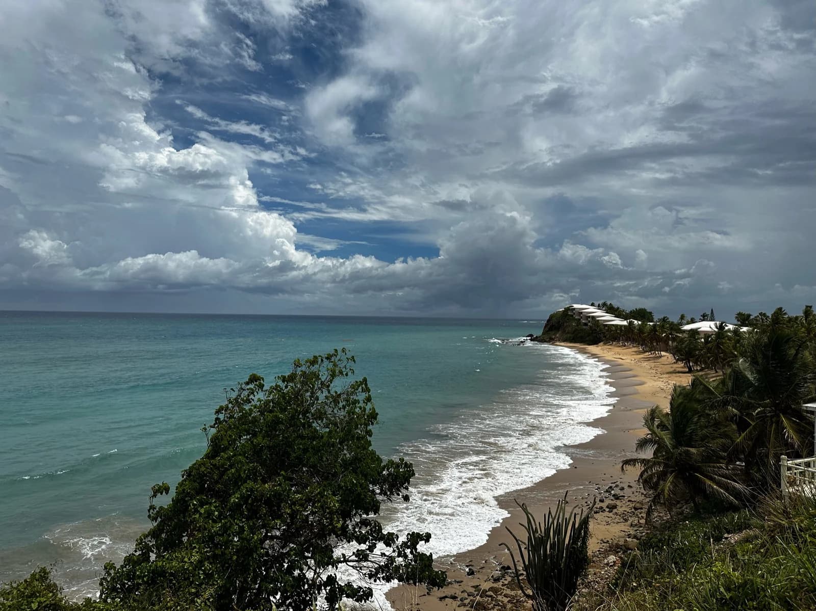 A beach in Saint Mary parish near Old Road on Antigua's south-west coast, with surf on the sand