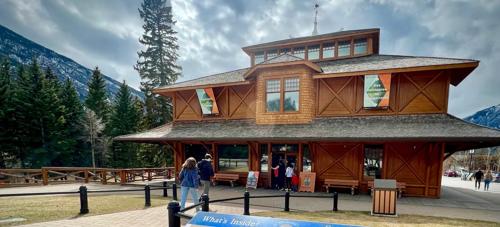 The shingled timber building of the Banff Park Museum by the river at the quiet end of the town centre