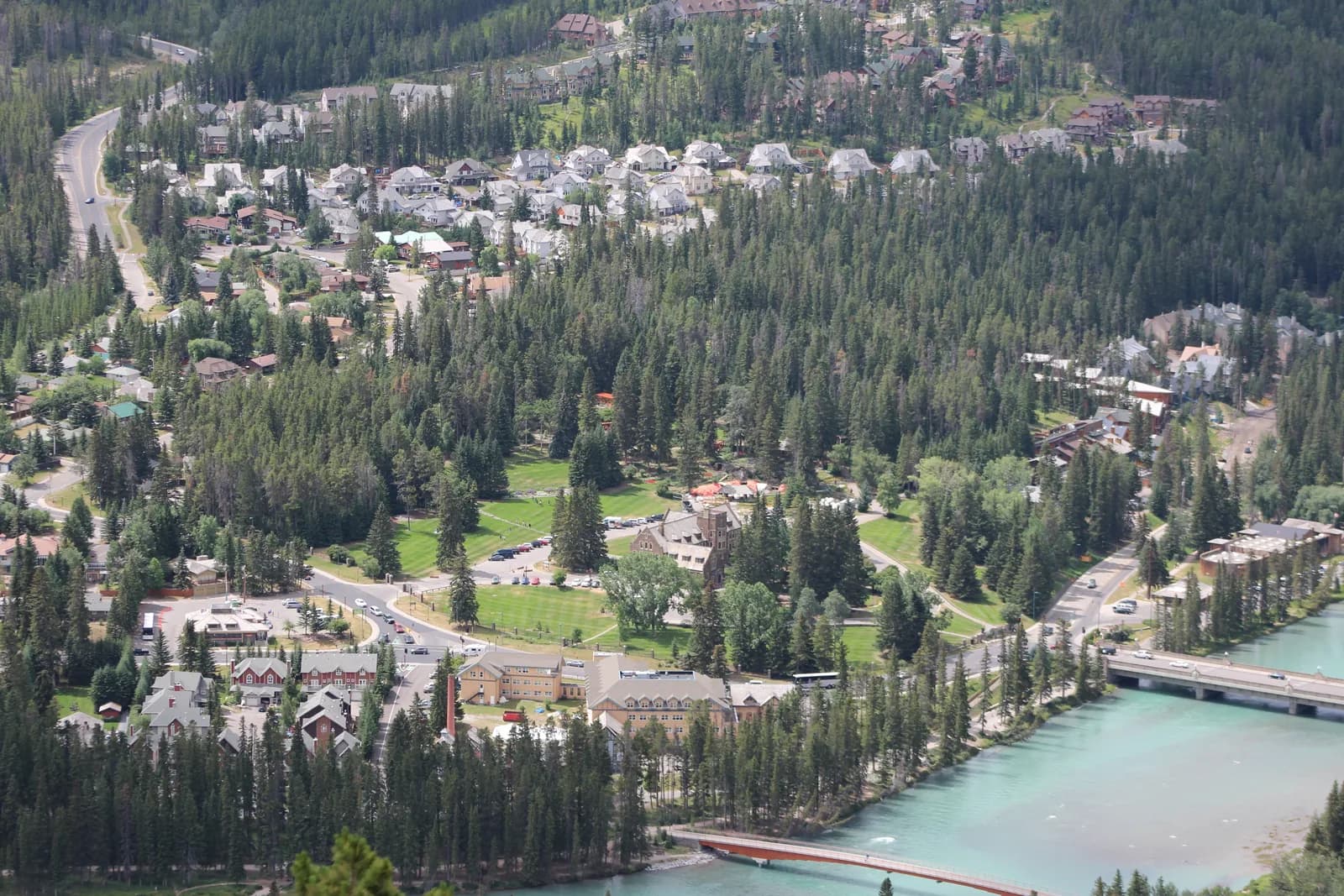 The wooded shoulder of Tunnel Mountain above the upper end of Banff Avenue