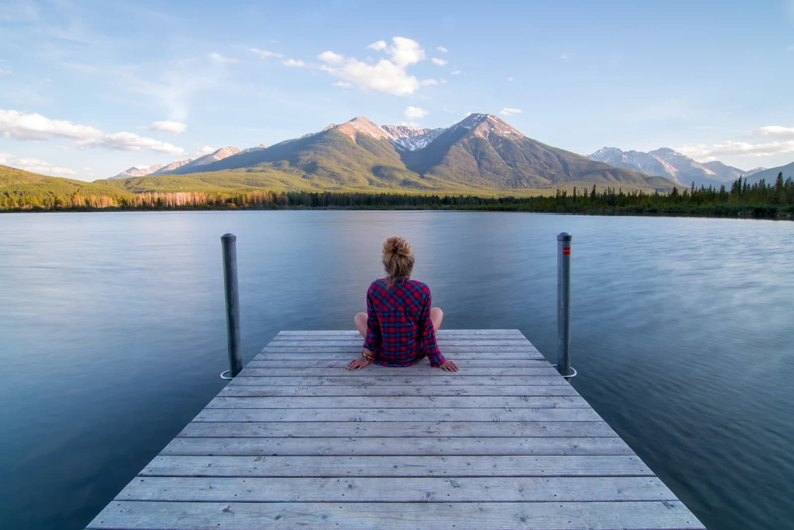 Still water and reeds at the Vermilion Lakes just west of Banff townsite, with the peaks behind
