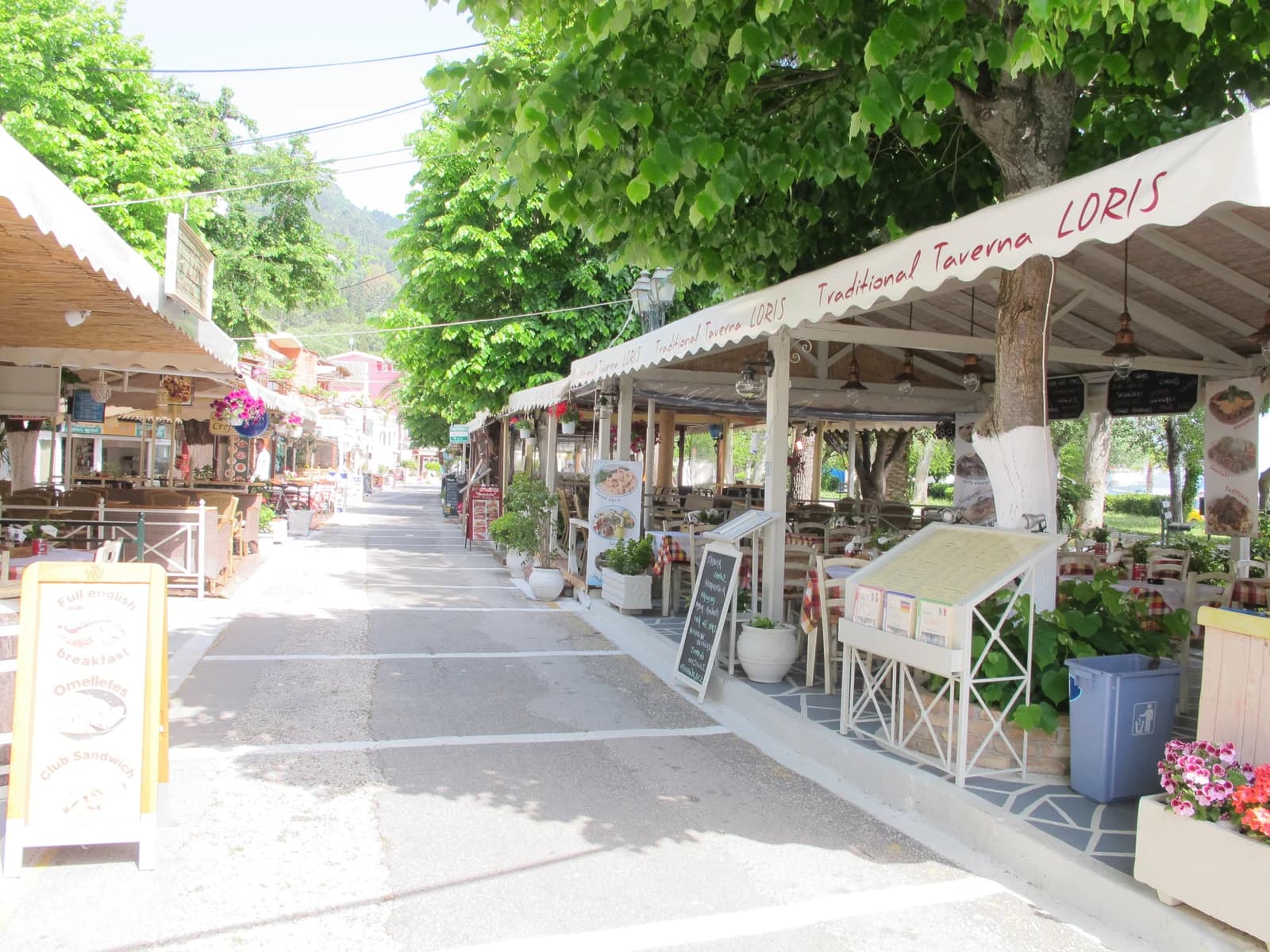 The taverna-lined seafront street in Benitses, the village just north of Agios Ioannis Peristeron on Corfu's east coast