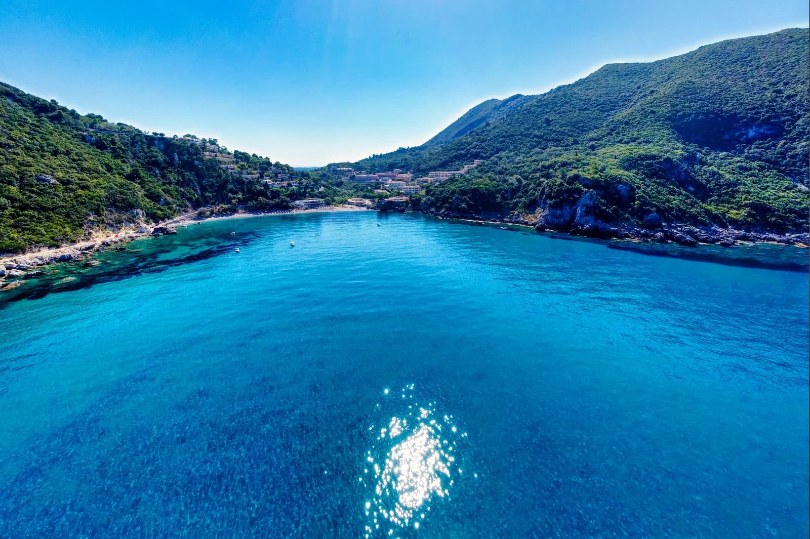 Ermones Bay on Corfu's west coast, a small beach at the foot of steep wooded hills
