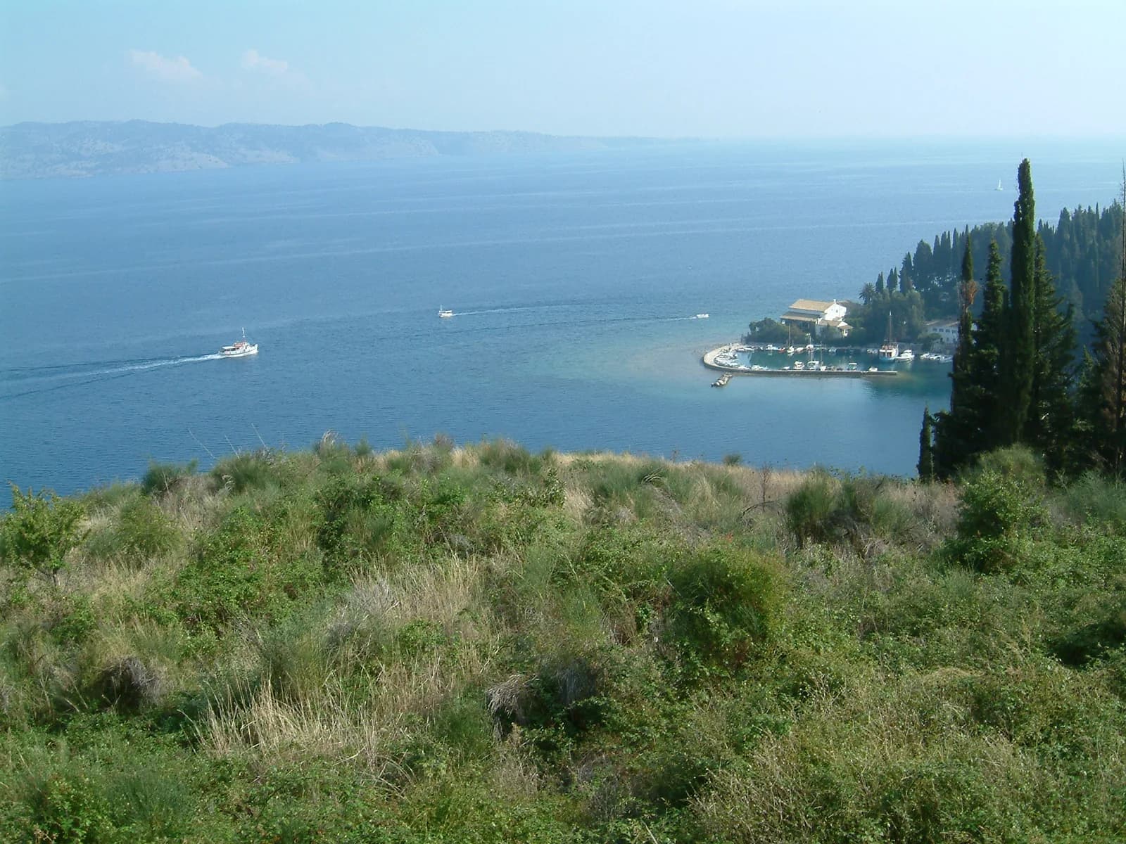 Kalami bay and its small harbour on Corfu's north-east coast, seen from the hillside above