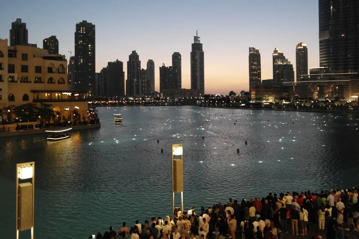 The Burj Khalifa lake in Downtown Dubai at dusk, where the fountain crowds gather