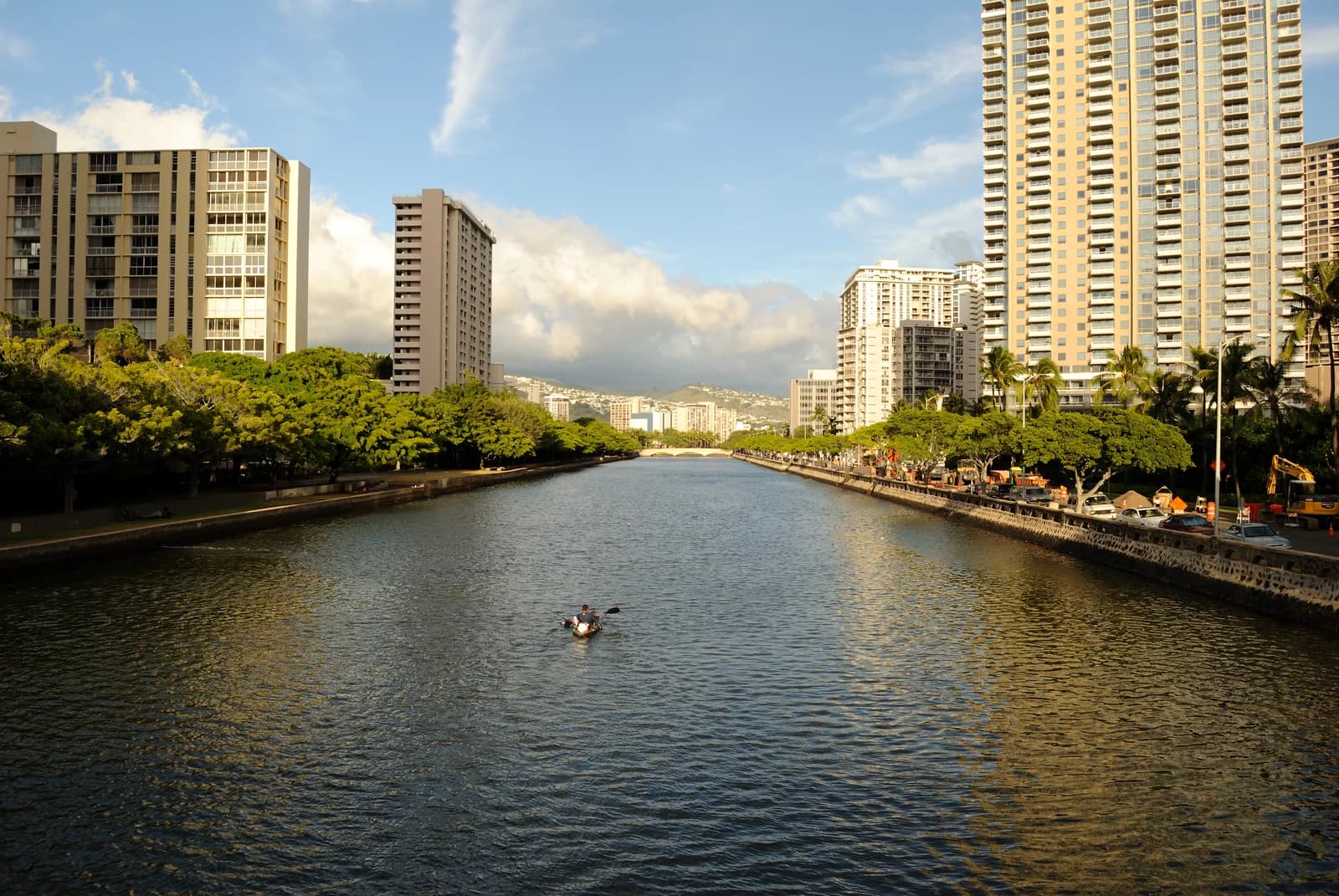 The Ala Wai Canal along the back edge of Waikiki, with a paddler and the towers behind