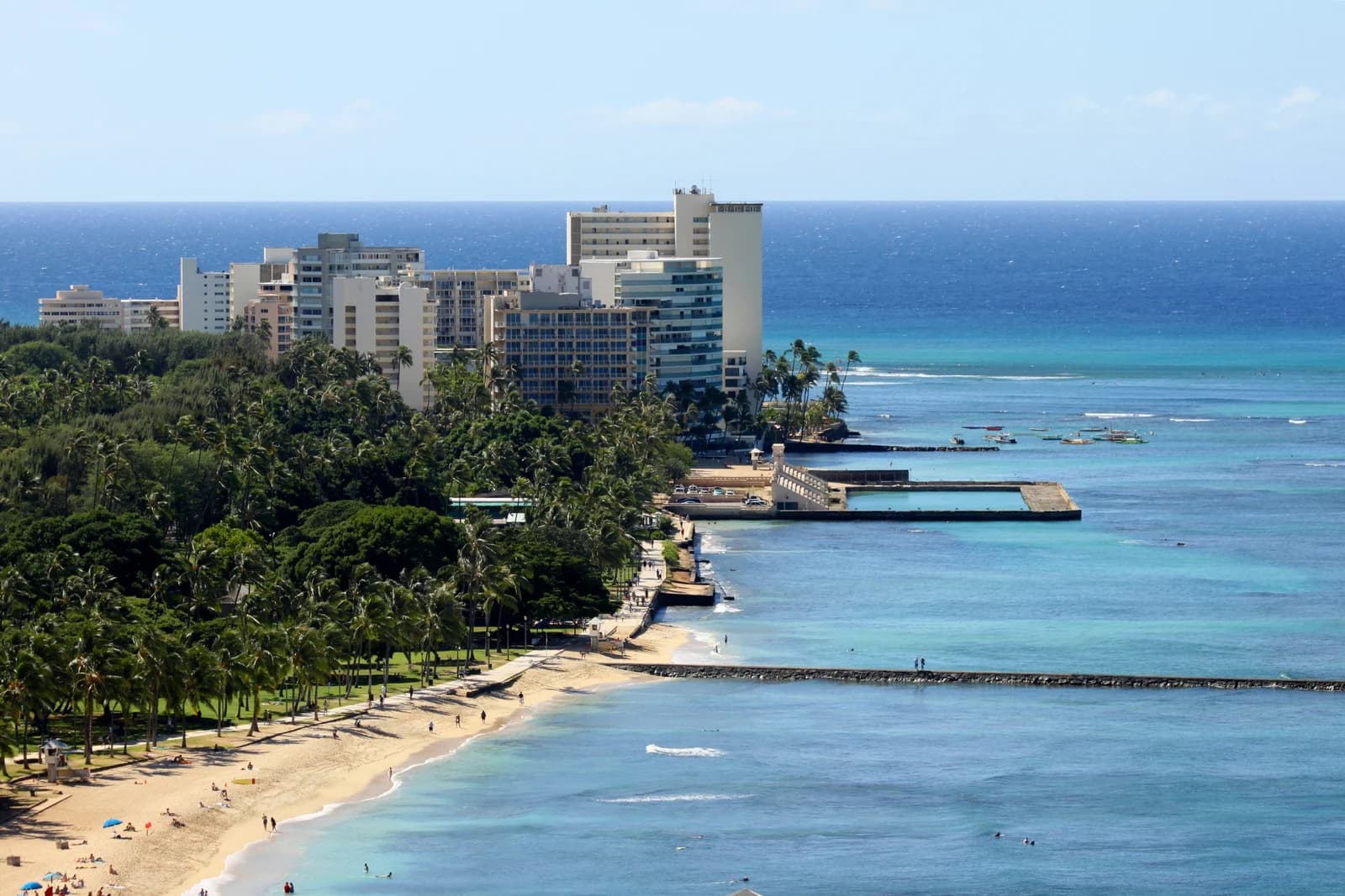 Swimmers and surfboards on the busy central stretch of Waikiki beach