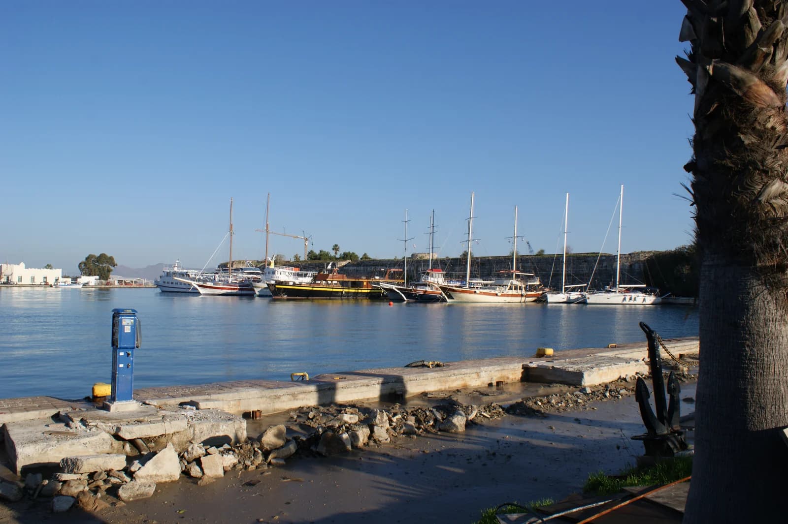 Boats moored in Kos Town harbour below the walls of the Neratzia castle, a few minutes from the seafront hotels