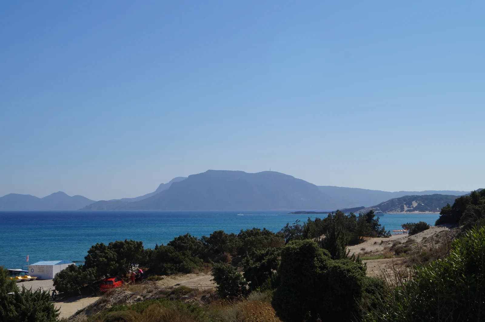 The sandy shore of Kefalos Bay in the south-west of Kos, with the Kefalos headland behind