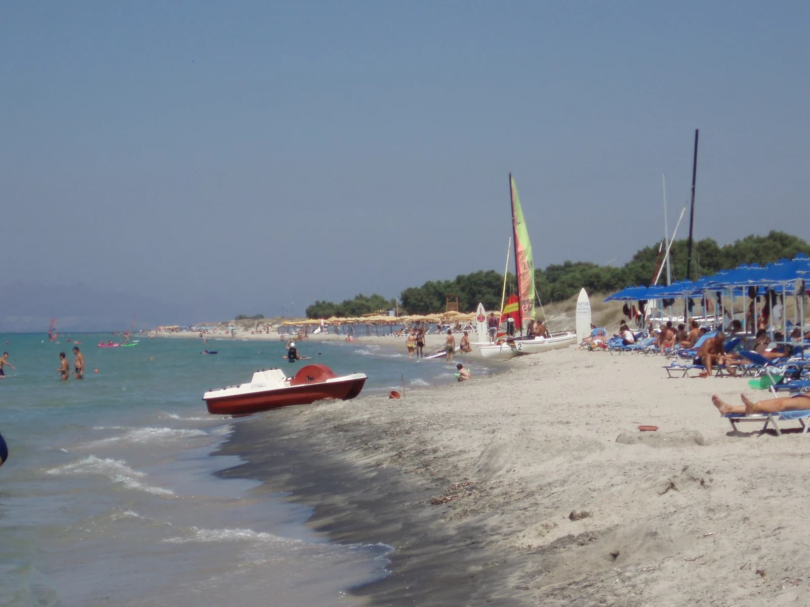 Sailing boats and sunbeds on Marmari beach on the north coast of Kos, a windsurf and kitesurf beach