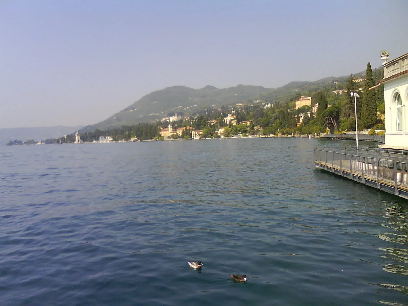The villa-lined western shore at Gardone Riviera, looking along the lake from the waterfront