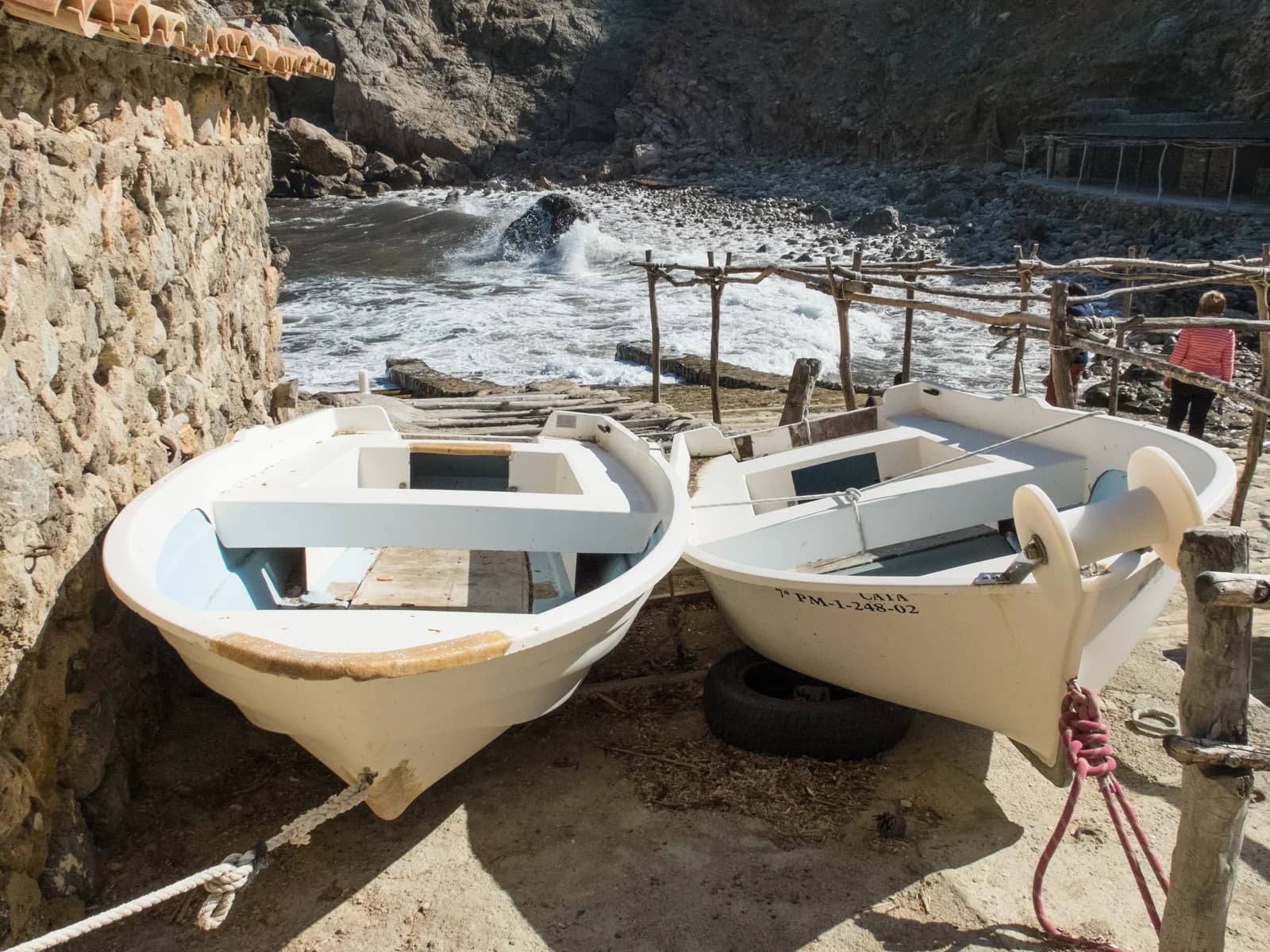Fishing boats pulled up at Cala Deià, the stony cove below the Tramuntana village of Deià
