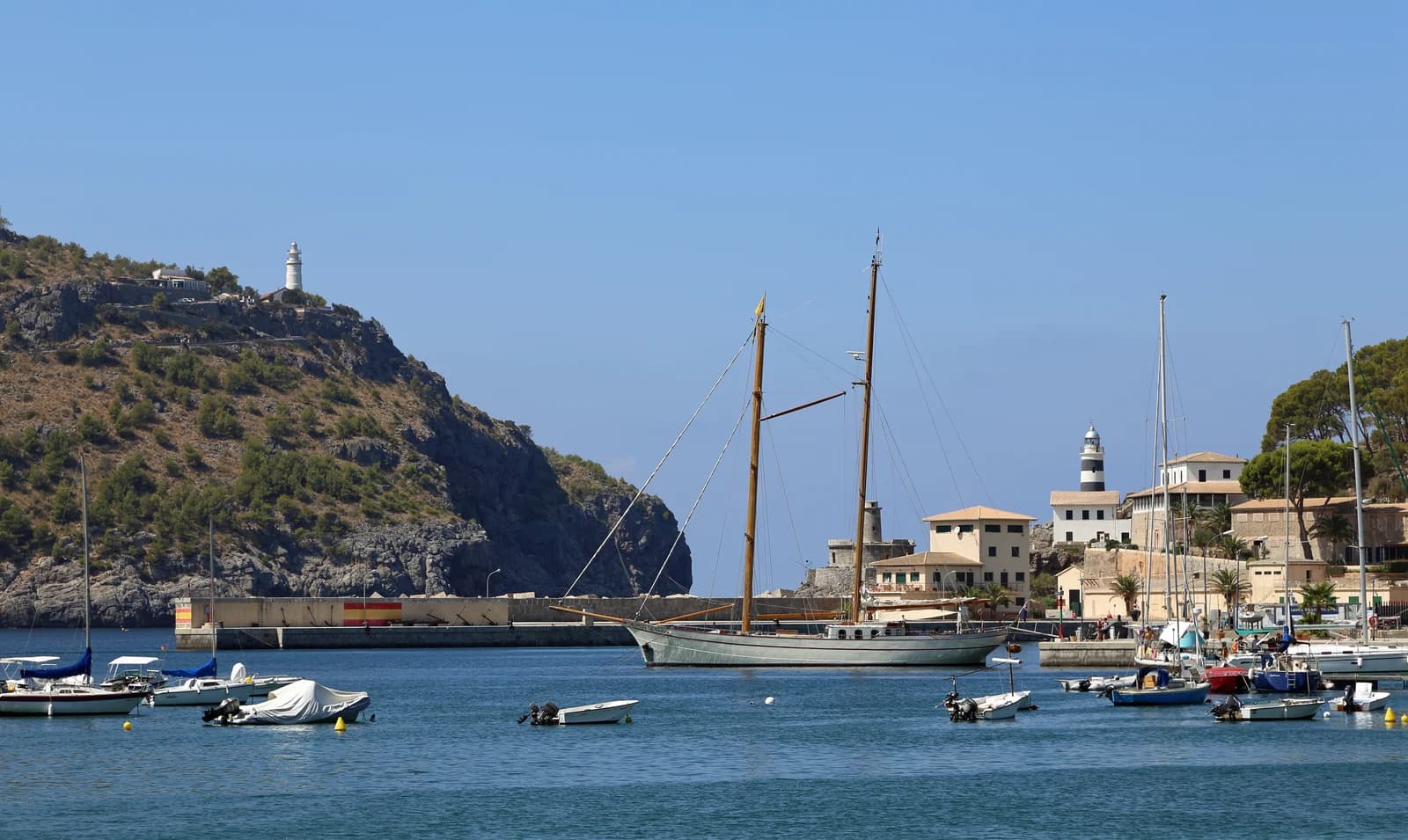 Boats in the bay of Port de Sóller, with the lighthouse on the headland above the harbour