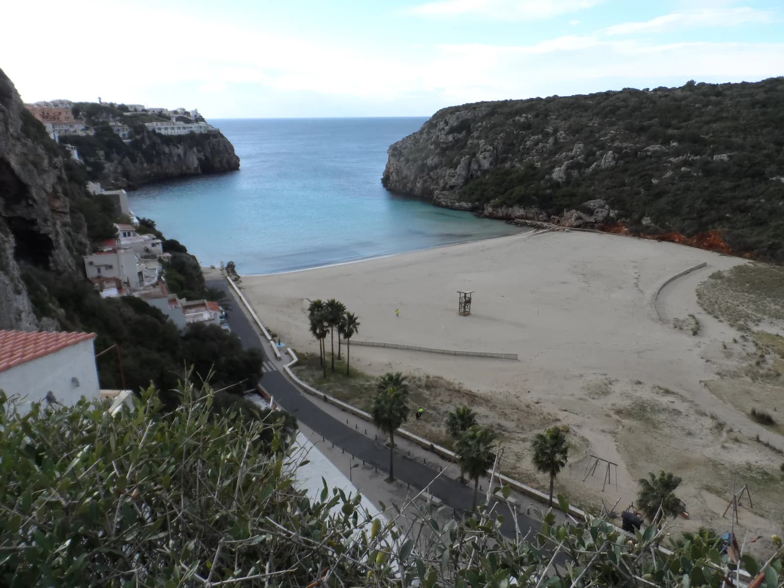 The beach at Cala en Porter between steep cliffs, the nearest town to the vineyard estates south of Alaior