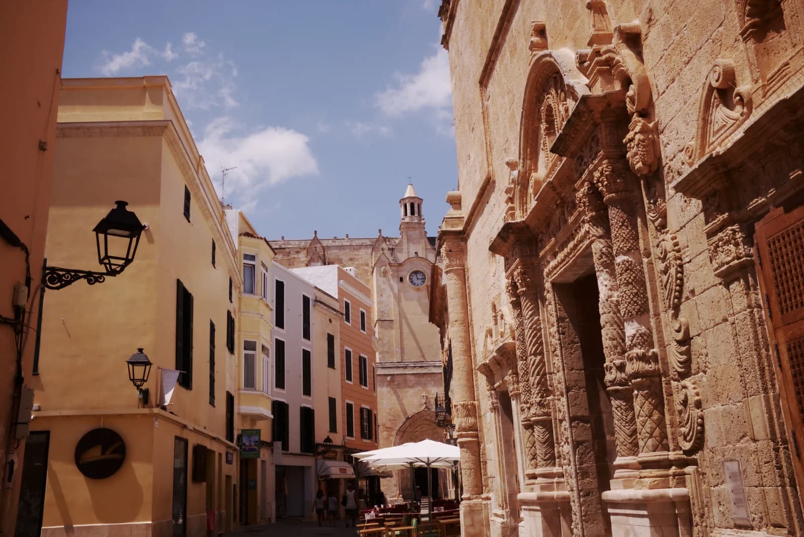 A carved palace doorway on a narrow street in Ciutadella's old town, the quarter of small adults-only hotels