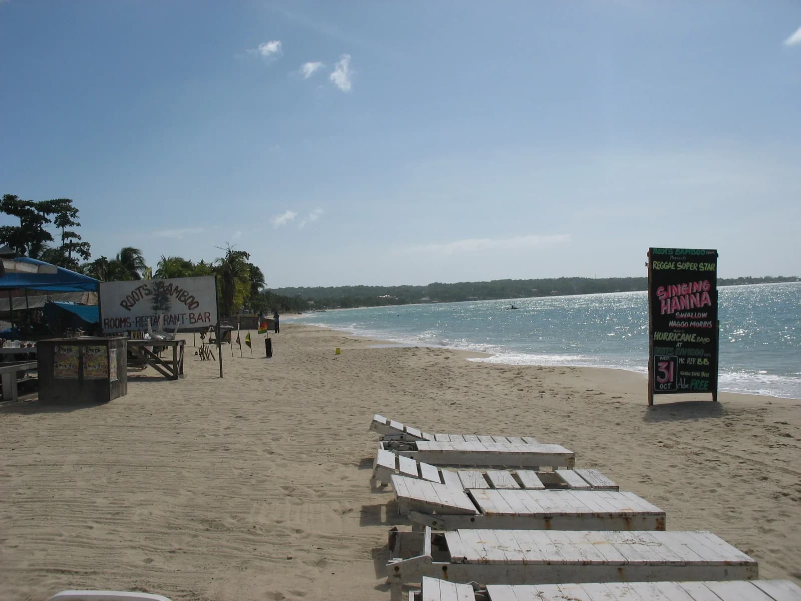 Wooden loungers on the sand of Negril beach, the strip where the Seven Mile Beach hotels sit