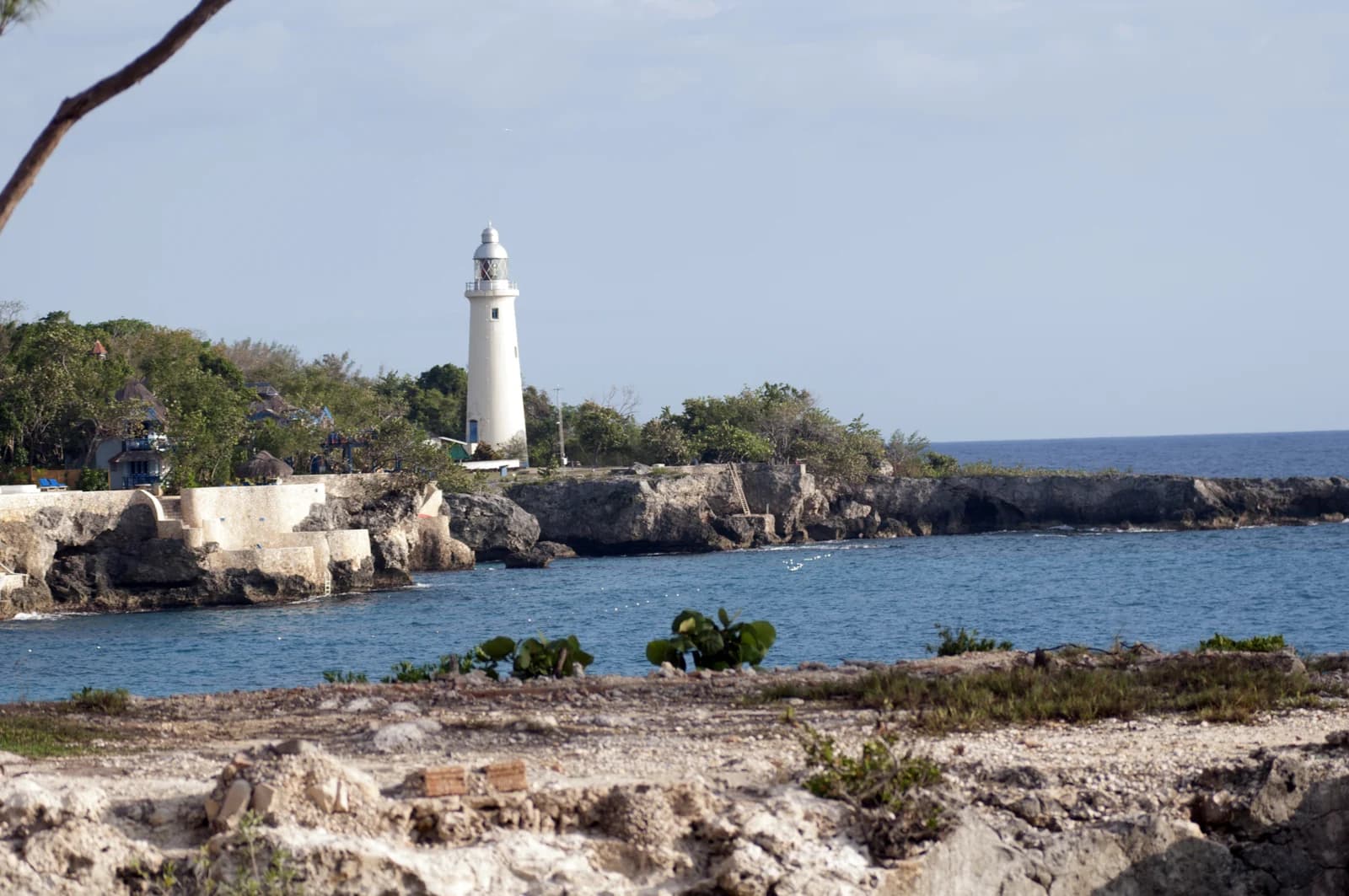 Negril Lighthouse above the low limestone cliffs at the far end of the West End