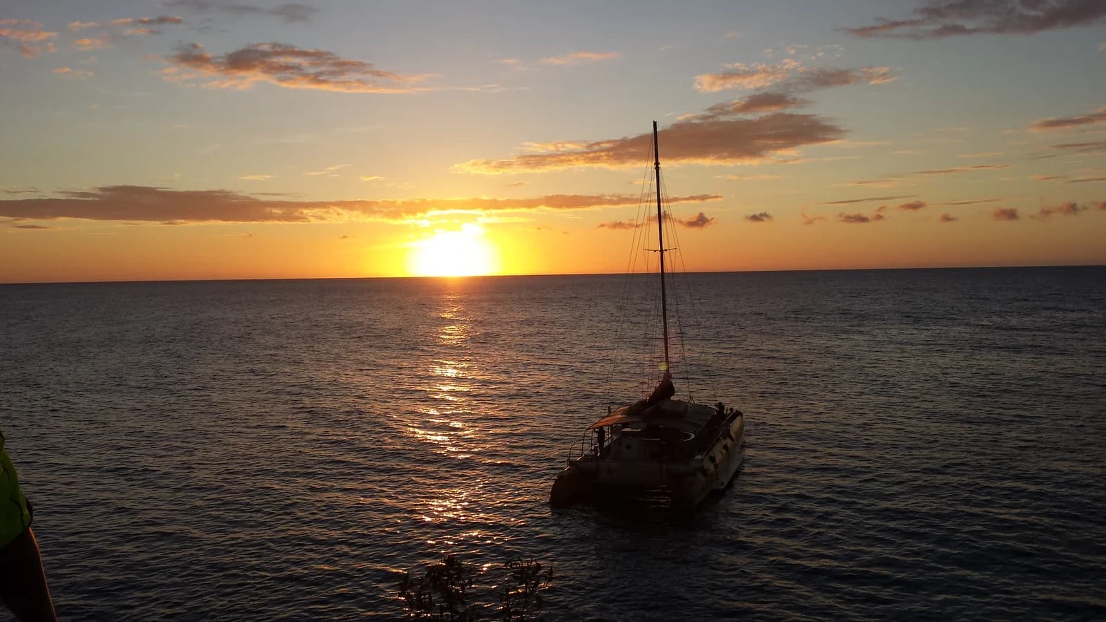 A catamaran off Rick's Cafe at sunset, on the Negril cliffs where the West End hotels sit