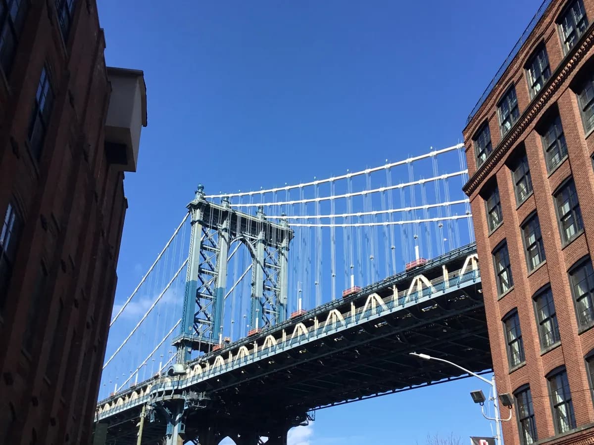 The Manhattan Bridge framed between brick warehouses in DUMBO, Brooklyn