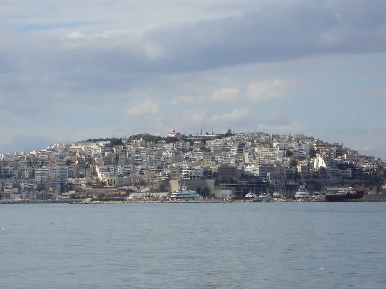 The white houses of Kastella climbing the hill above Pasalimani in Piraeus, seen across the water