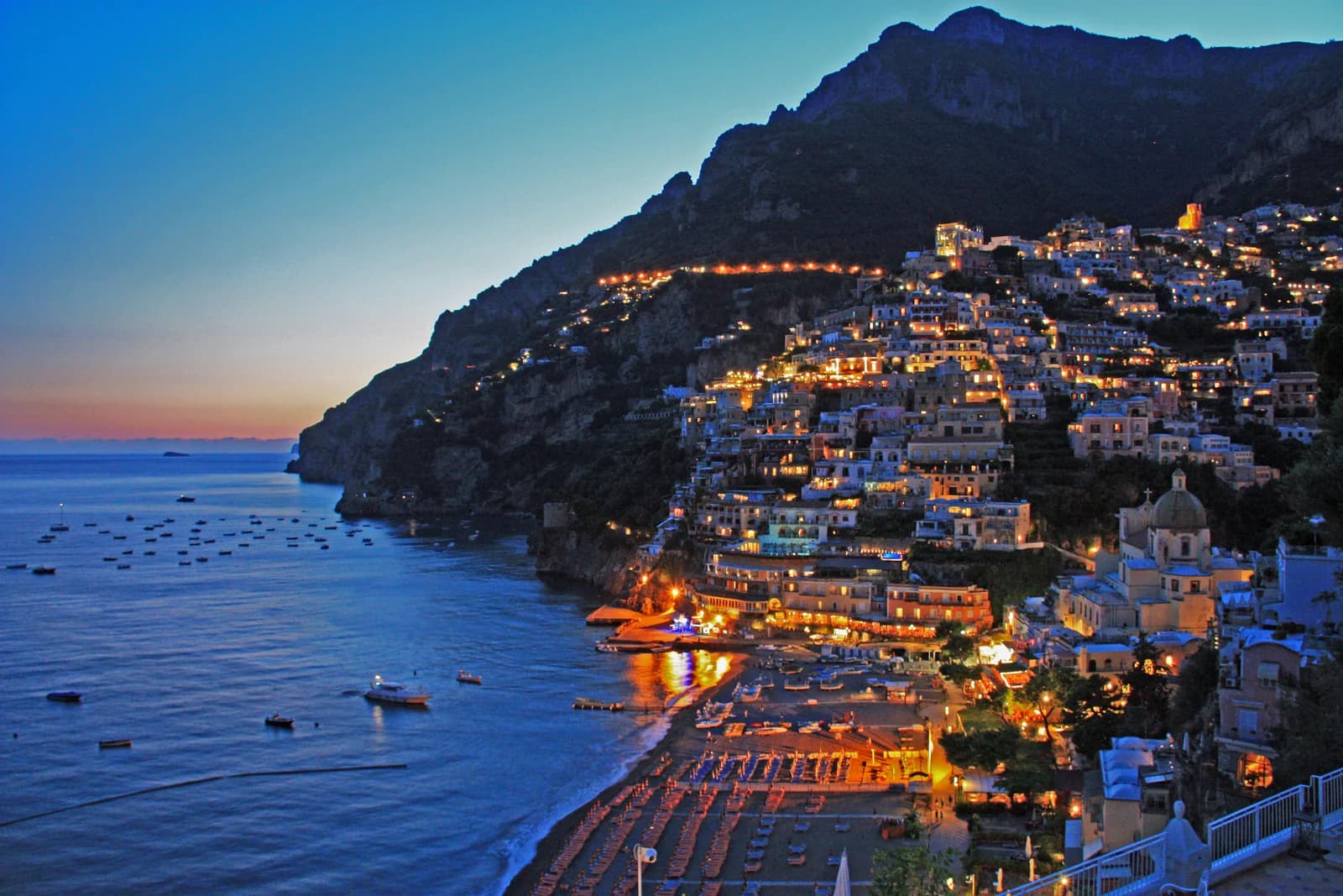 Positano at sunset from the west, the hour the high terraces keep light longest
