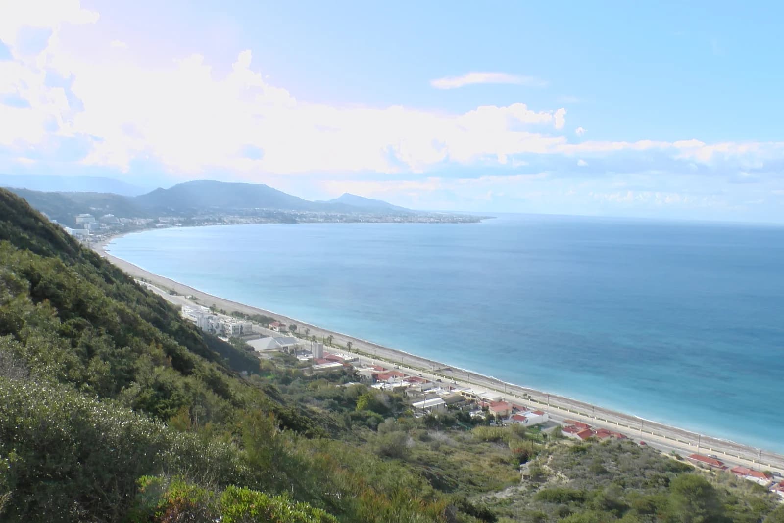The long straight shoreline at Ixia on the west coast of Rhodes, seen from the hillside above