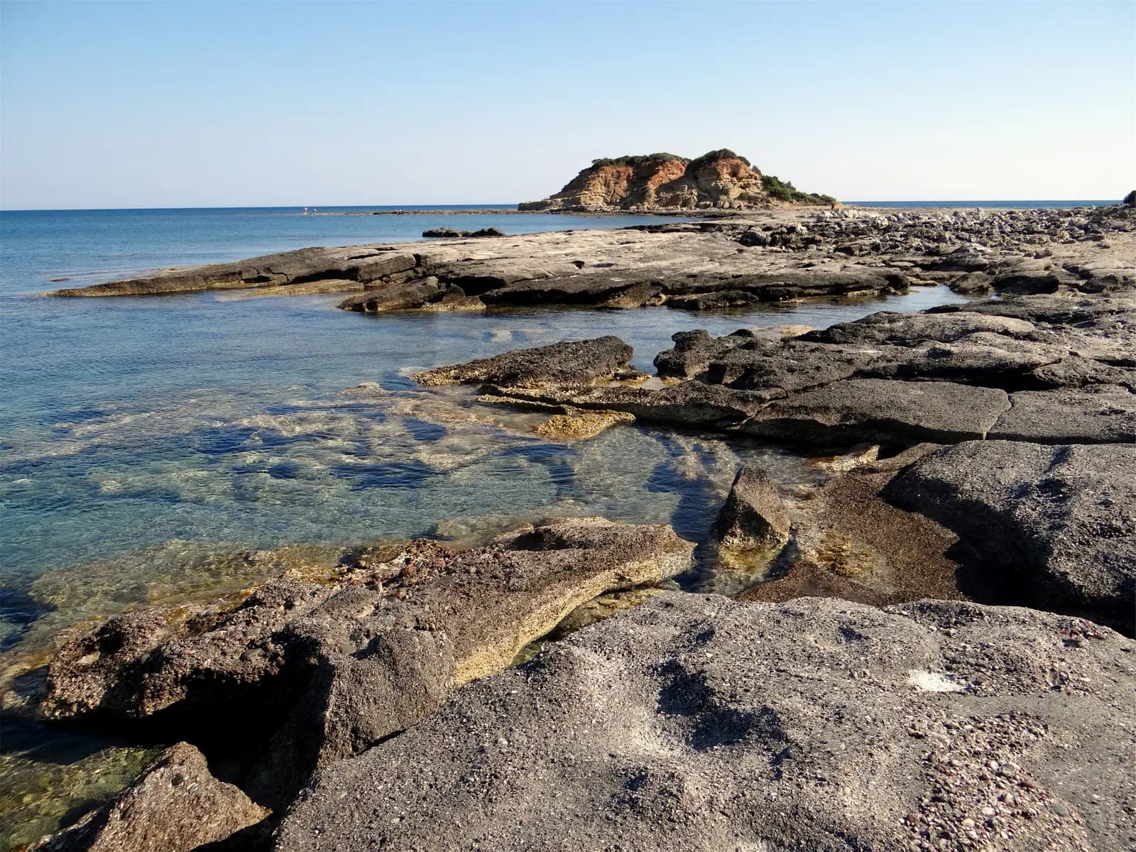Flat rocks and calm sea along the shore at Kiotari in the quiet south of Rhodes