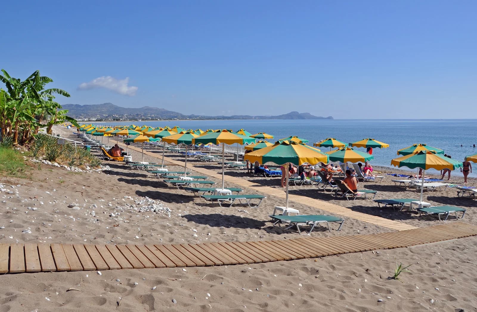 Umbrellas and a boardwalk across the beach at Kolymbia, halfway between Rhodes Town and Lindos