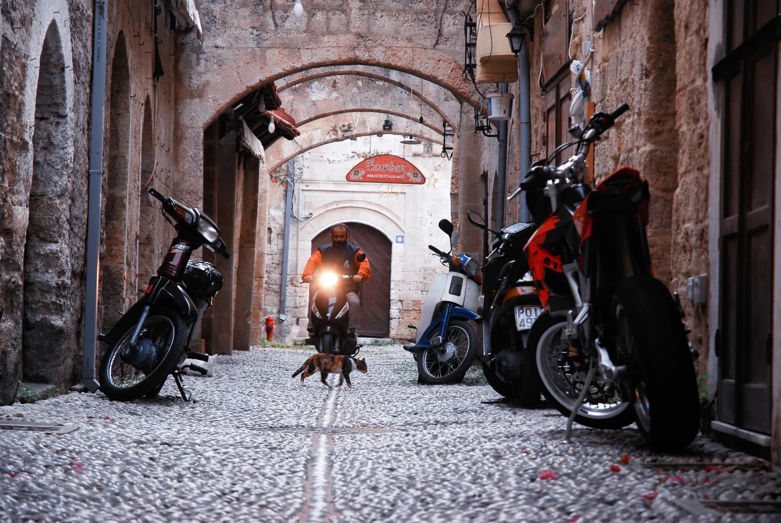 A pebbled lane under stone arches in the medieval Old Town of Rhodes, a UNESCO World Heritage site