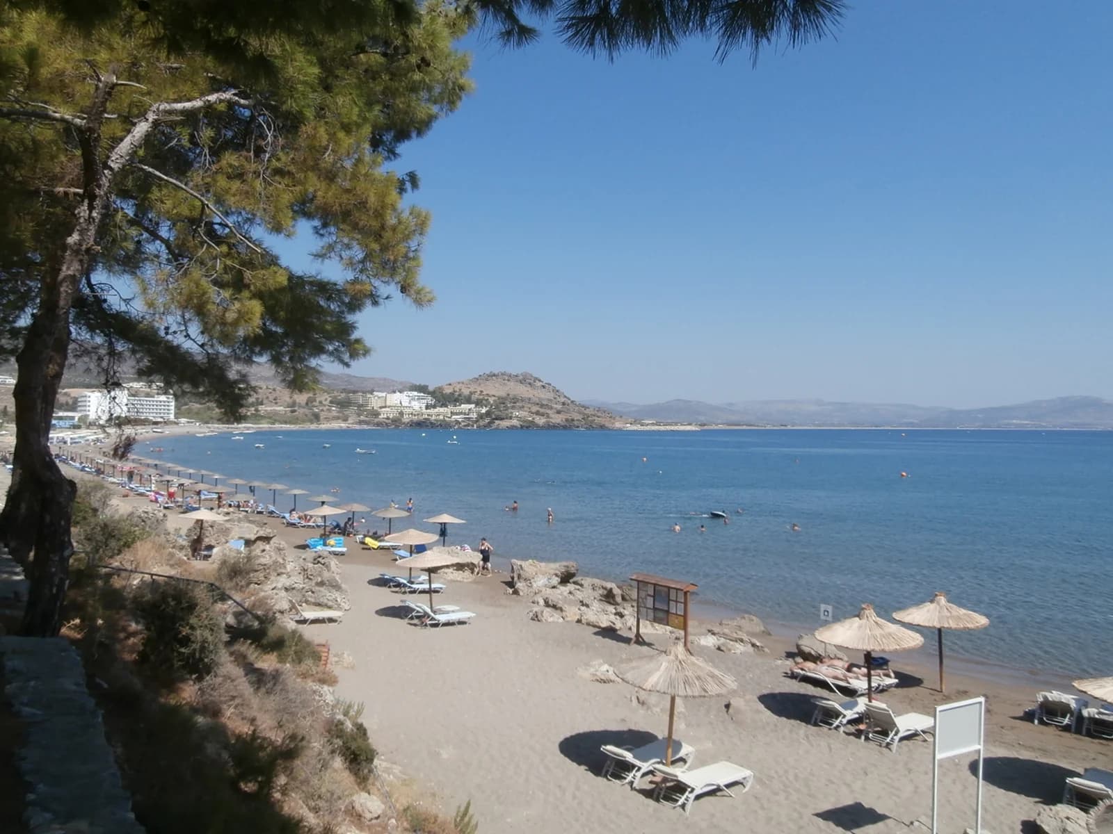 Sunbeds and umbrellas on Vlycha Beach, the bay just north of Lindos on the east coast of Rhodes
