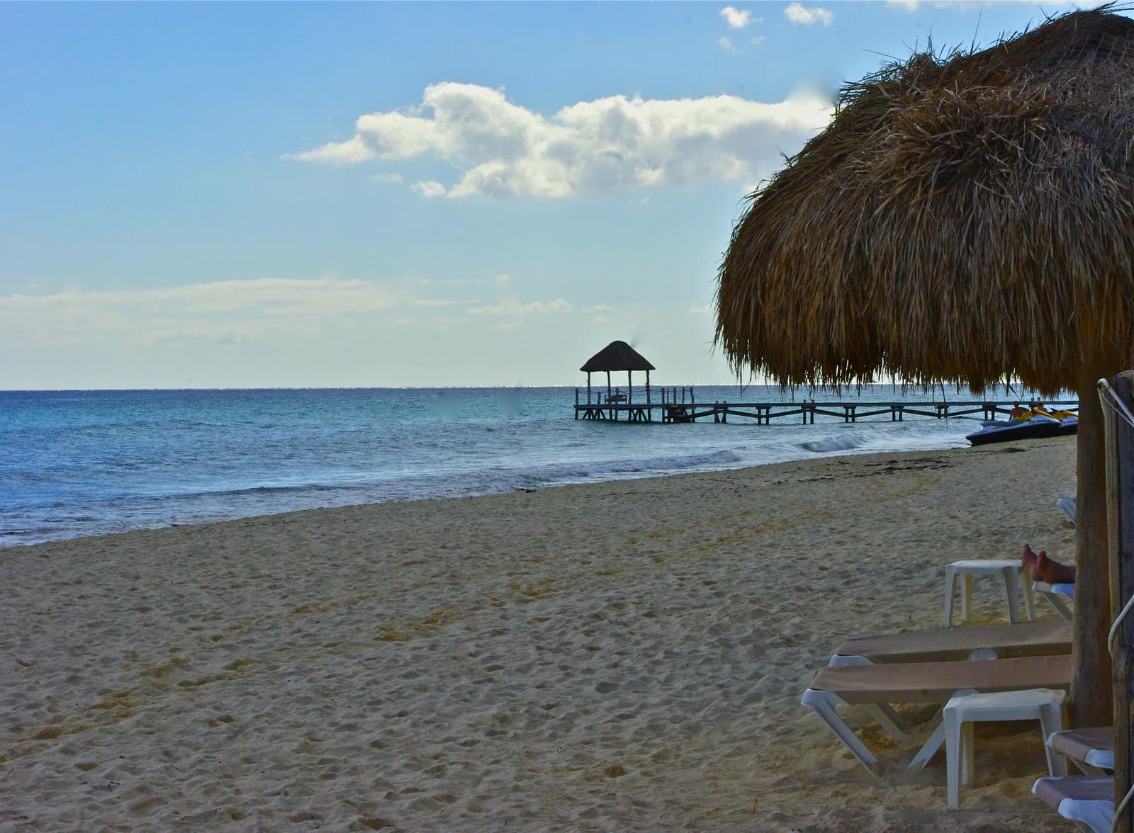 A palapa and a wooden pier on Playa Xcalacoco near Playa del Carmen