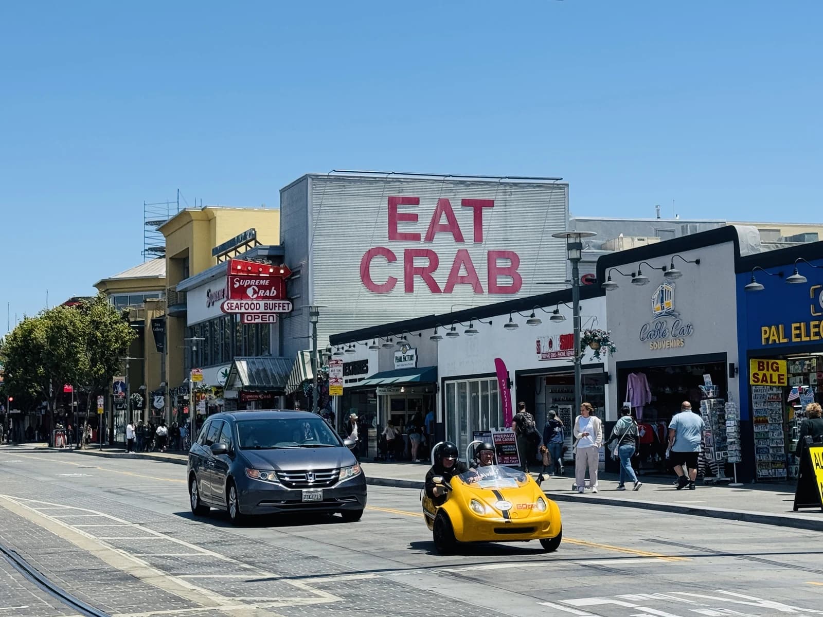 Tourists stroll past crab stands and souvenir shops on Jefferson Street at Fisherman's Wharf