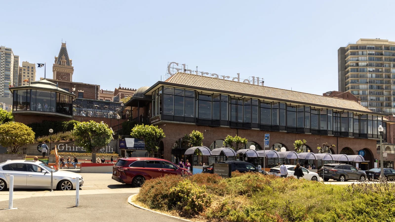The brick buildings and rooftop sign of Ghirardelli Square on a sunny afternoon