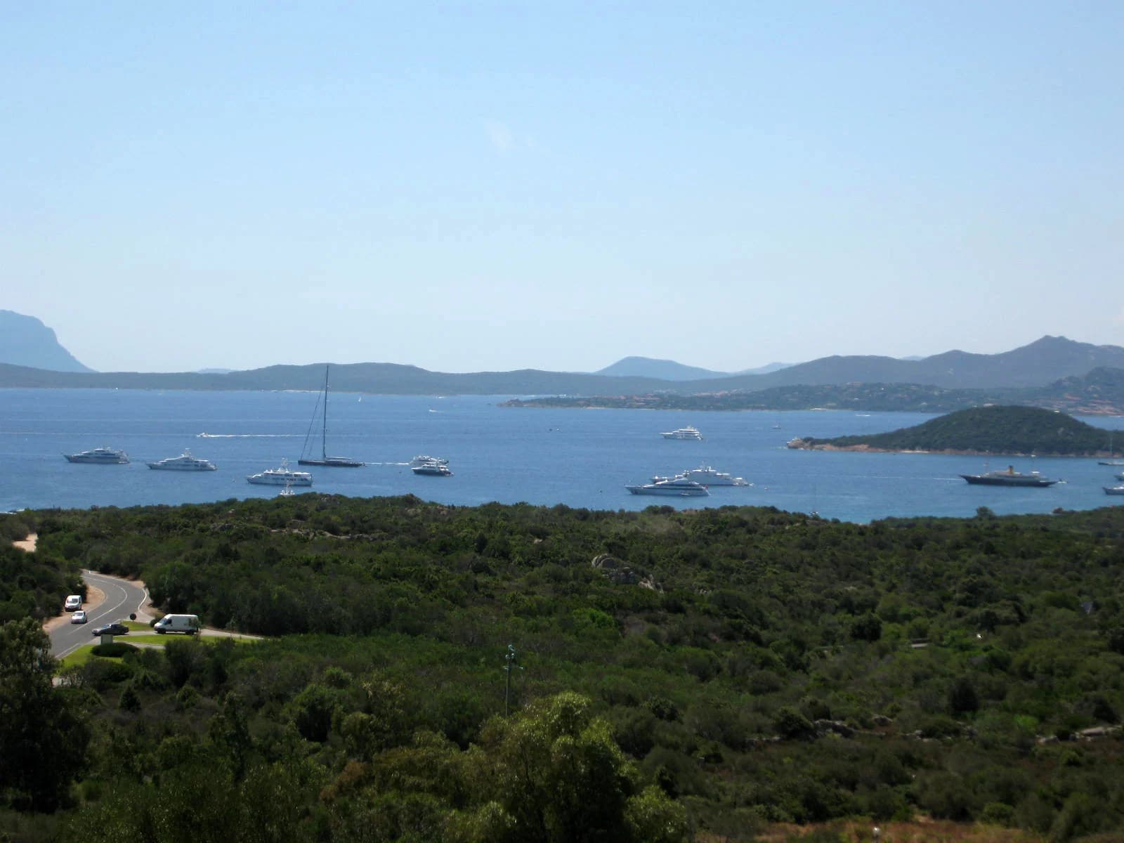Yachts at anchor in the bay of Cala di Volpe on the Costa Smeralda, with the islands offshore
