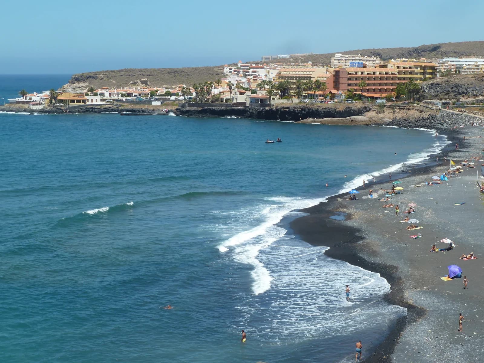 The dark-sand bay and village of La Caleta in Costa Adeje, home to some of the adults-only hotels in Tenerife