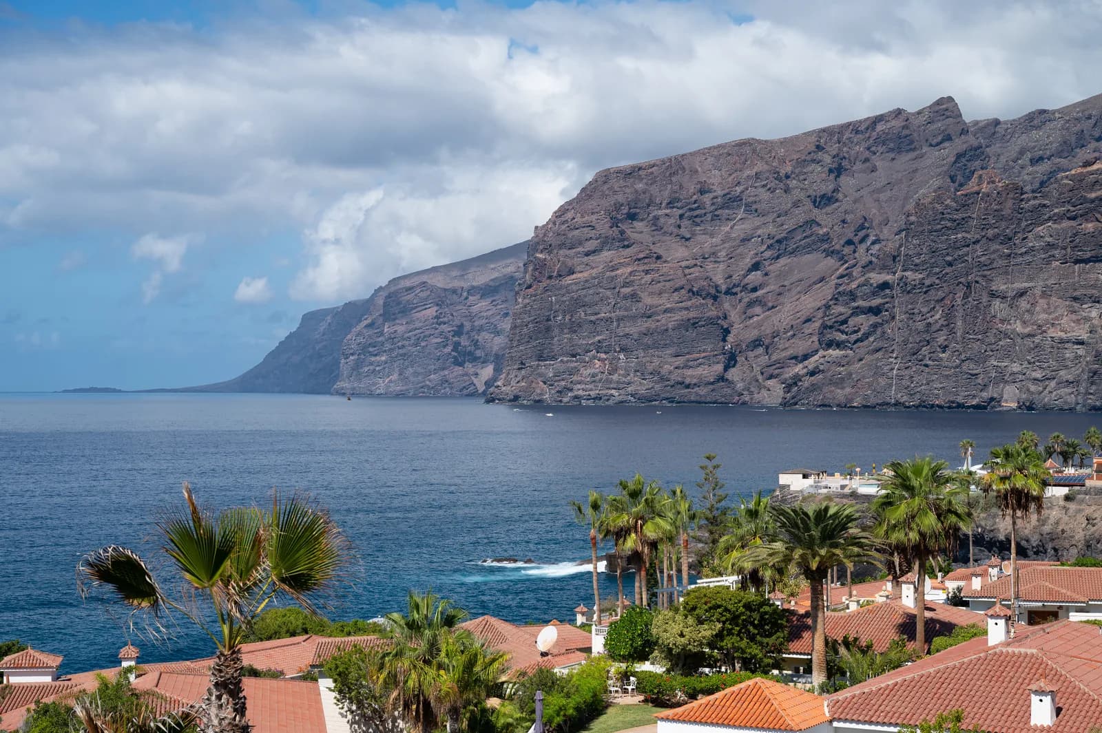 The Los Gigantes cliffs rising from the sea beyond the rooftops of Puerto de Santiago on Tenerife's west coast