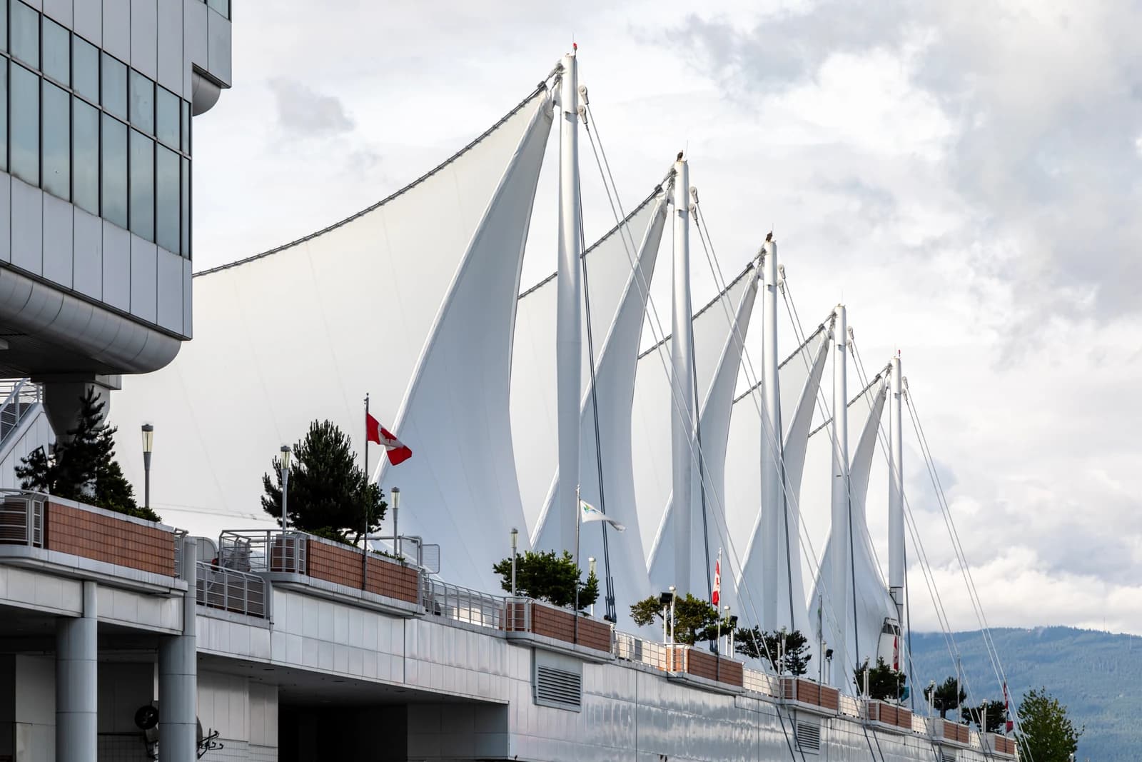 The white sail canopies of Canada Place seen from the promenade deck around the building