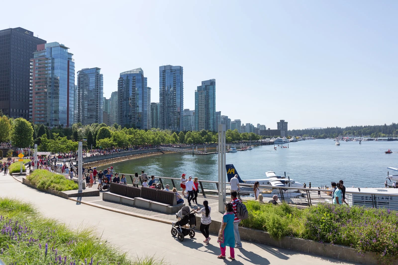 The Coal Harbour seawall in Vancouver, with float planes at the dock and towers along the shore