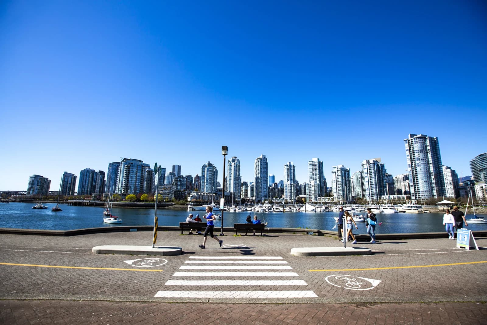 The False Creek seawall in Vancouver, where the path passes the marina and the towers beyond